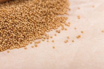 fresh amaranth grains on a rustic background