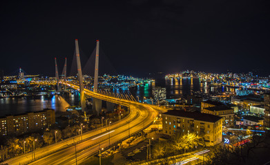 view the city at night, the bridge across the Bay at night, full of bright lights.