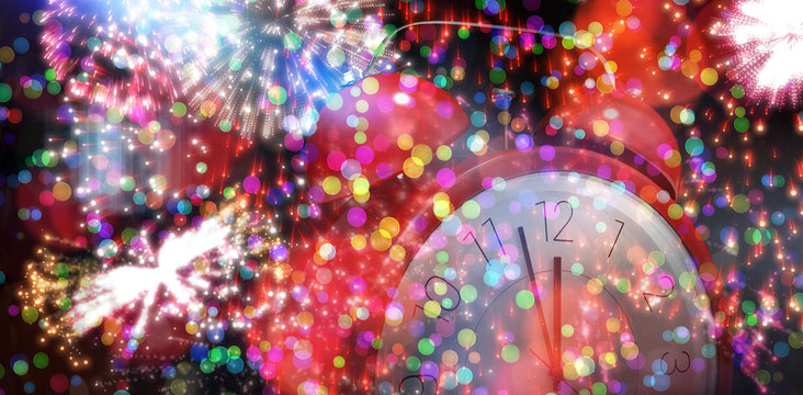 Alarm clock counting down to twelve against colourful fireworks exploding on black background