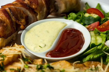 Delicious Chicken rolls with cheese and bacon on a plate close-up. horizontal