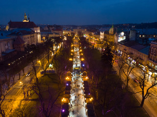 Fototapeta na wymiar overhead view of european city in night time. people walk by fair in evening