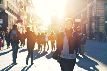 Urban girl striding through city area - Powered by Adobe