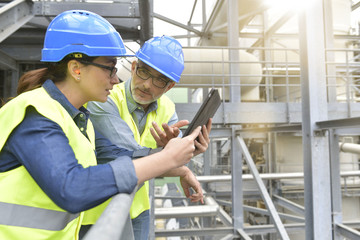 Industrial engineers working in recycling plant with tablet