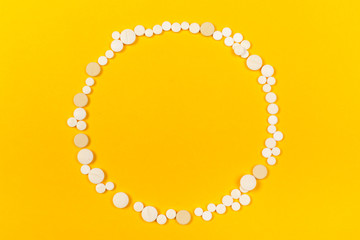 White medical pills on color background