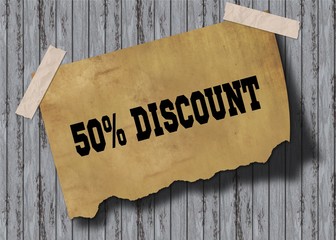 Old brown paper with 50 PERCENT DISCOUNT text on wooden background.