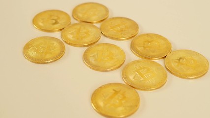 The golden coins of bitcoins lie chaotically on the table. Blockchain is the technology of the future