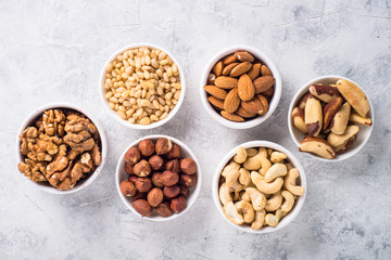 Nuts assortments on stone table top view.