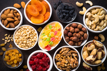 Nuts and dried fruits assortment on stone table top view.