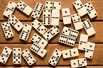 Domino game on wooden background . Top view