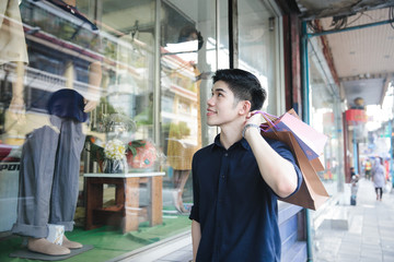 Young asian male shopping