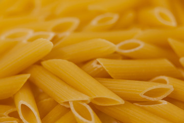 Pennette pasta on wooden surface