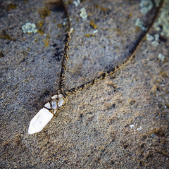 Natural gemstone necklace on rocky backround