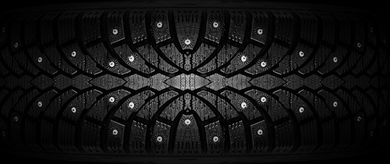  Winter rubber with spikes on a black background close-up. © Vitaly Krivosheev