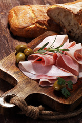 Sliced ham on wooden background. Fresh prosciutto. Pork ham sliced