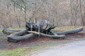 Funny shape wooden bench in a park. Landscape.