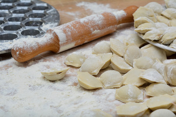 Preparation of homemade meat dumplings. Traditional Russian dish. Process of making dumplings with meat. Homemade uncooked pelmeni