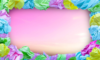 many wrinkled color paper frame on blurry background.