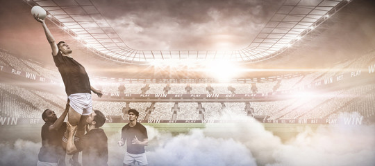Digital composite image of stadium against rugby players jumping for line out - Powered by Adobe