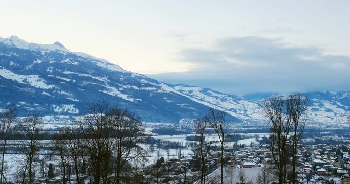 Liechtenstein in winter. Aerial view of Vaduz, Liechtenstein at night, illuminated streets with colorful sunset sky over the mountains.