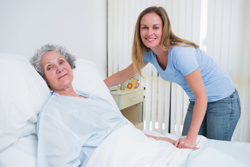 Woman holding the hand of a patient in a room