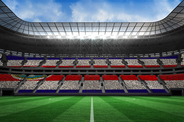 Fototapeta na wymiar Costa rica national flag in large football stadium with white fans