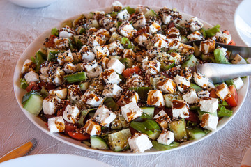 Greek salad close up with cheese, tomatoes and olives