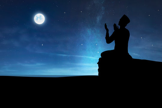 Silhouette of muslim man praying to god