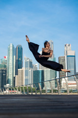 Fototapeta na wymiar Elegant ballet dancer woman dancing ballet in the city