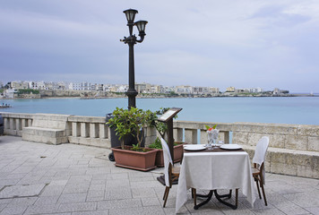 Italy, Puglia, Otranto, restaurant at the bay, referred to as the road of Otranto - obrazy, fototapety, plakaty