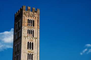 Fototapeta na wymiar Saint Fridanius Basilica old medieval bell tower in the town of Lucca, Tuscany. Erected between the 12th and 13th century (with copy space)