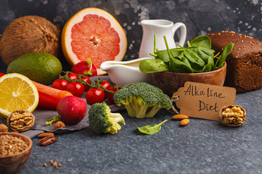 Healthy food background, trendy Alkaline diet products - fruits, vegetables, cereals, nuts, oil, dark background