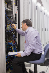 Naklejka na ściany i meble Technician with a clipboard checking servers