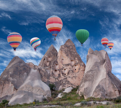 Colorful hot air balloons flying over Red valley in Cappadocia, Anatolia, Turkey