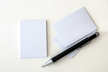 stacking of a mockup empty white business card with elegance pen  on white paper background , template for business  branding identity design