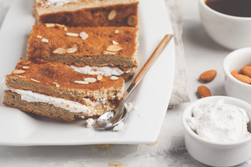 Vegan cake with coconut cream and almonds. Light background, healthy vegan dessert. Healthy vegan food concept.