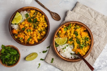 Vegan Sweet Potato Chickpea curry in wooden bowl on light background, top view, copy space. Healthy vegetarian food concept. - obrazy, fototapety, plakaty