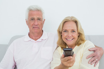 Senior couple watching television
