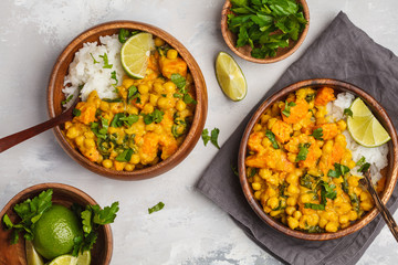 Vegan Sweet Potato Chickpea curry in wooden bowl on a light background, top view, flat lay. Healthy vegetarian food concept.