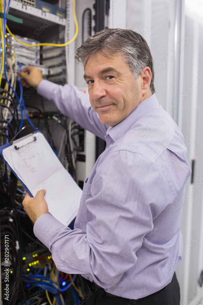 Poster data center worker checking the servers