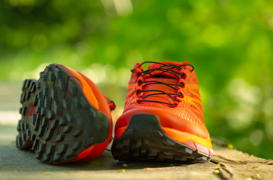 Close up of a pair of colorful trail running shoes. Shallow D.O.F.