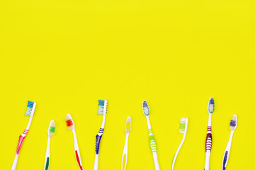 Toothbrushes on yellow background
