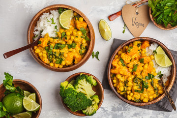 Vegan Sweet Potato Chickpea curry in wooden bowl on a light background, top view, flat lay. Healthy vegan food concept. - obrazy, fototapety, plakaty