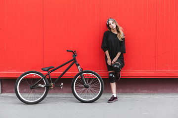 Girl in hockey jersey style with street bicycle