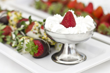 Fresh strawberries in chocolate with whipped cream