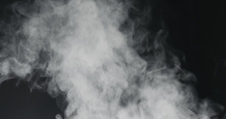 vapor steam rising over black background