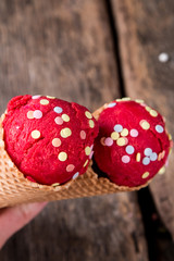 Ice cream, Berry ice cream scoop in waffle cone on wooden table