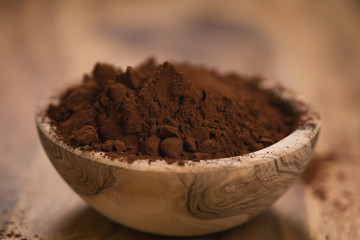 cacao powder in wood bowl on table