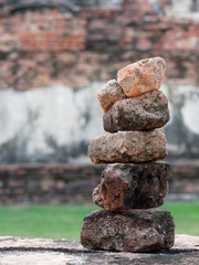Stack of old ruin red brick in Phra Ram temple, archaeological or historic site, or ancient remains, famous tourist destination in Ayutthaya, Thailand with concepts of zen, meditation, and relaxation