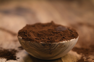 cacao powder in wood bowl on table