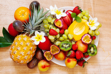 Naklejka na ściany i meble Fresh fruits. Assorted exotic fruit colorful background overhead
